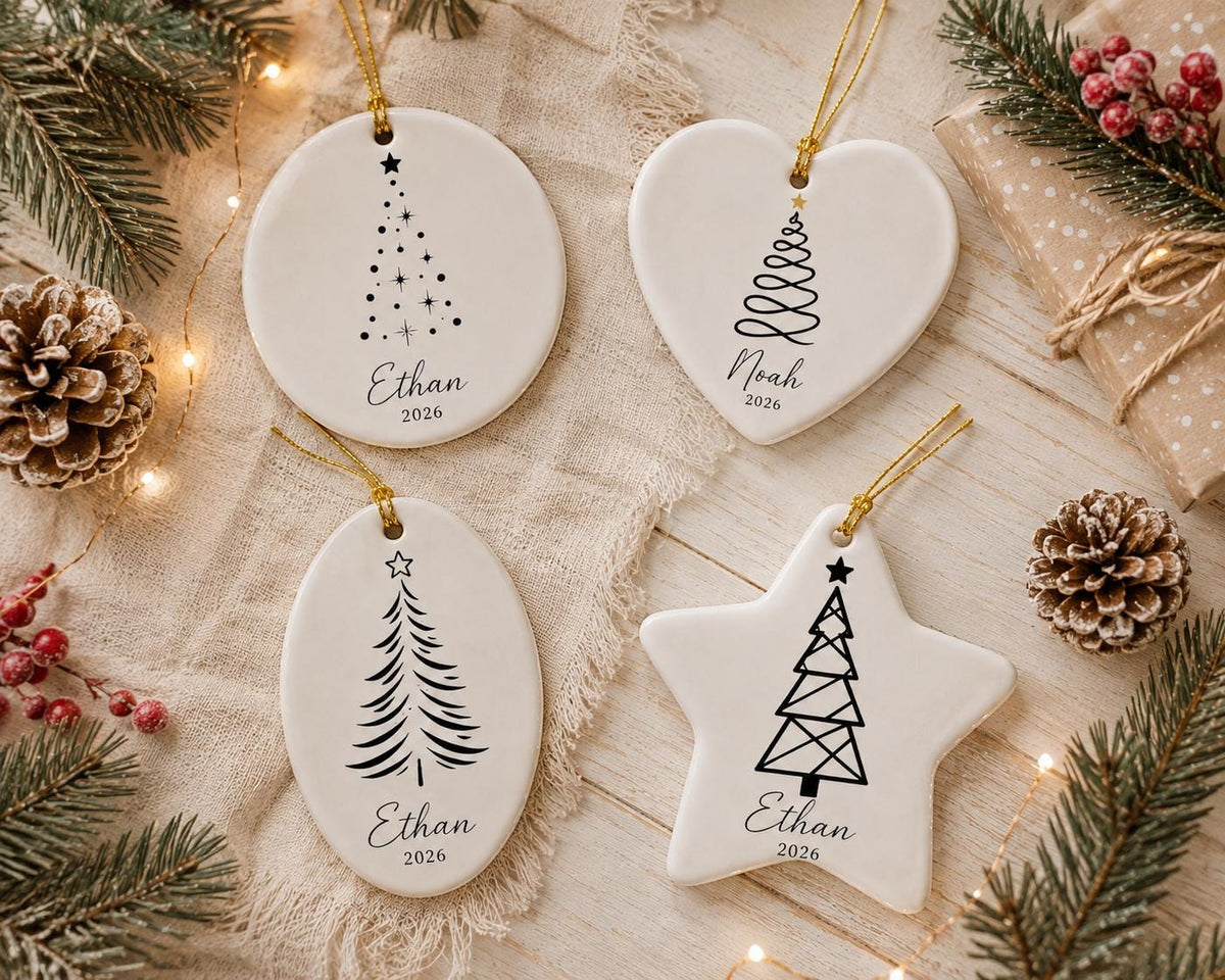 Personalized minimalist Christmas tree ceramic ornaments in circle, heart, oval and star shapes with names Ethan and Noah