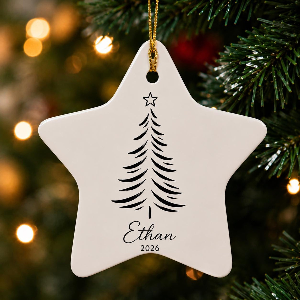 Star-shaped ceramic ornament with a black pine tree design and the name Ethan 2026