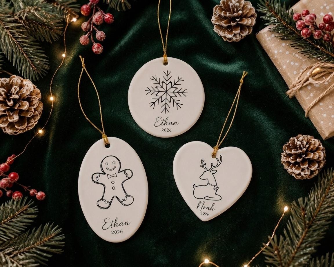 Snowflake, gingerbread man and reindeer ceramic ornaments with names hanging by pinecones and berries