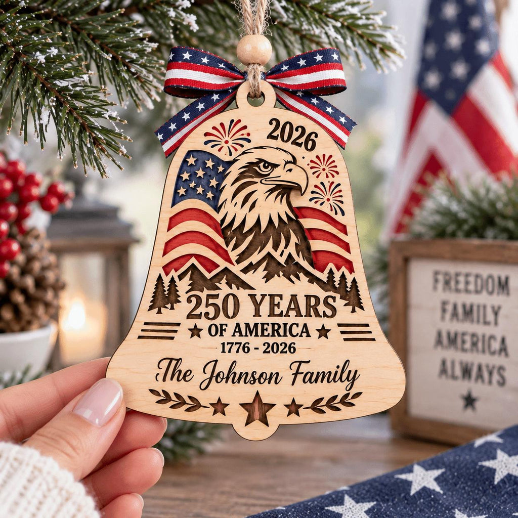 Hand holding a personalized 250 Years of America eagle bell ornament
