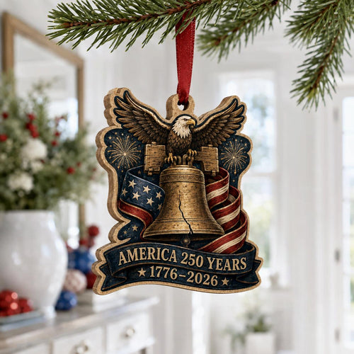 1776 to 2026 America 250 years Liberty Bell ornament hanging on a pine branch