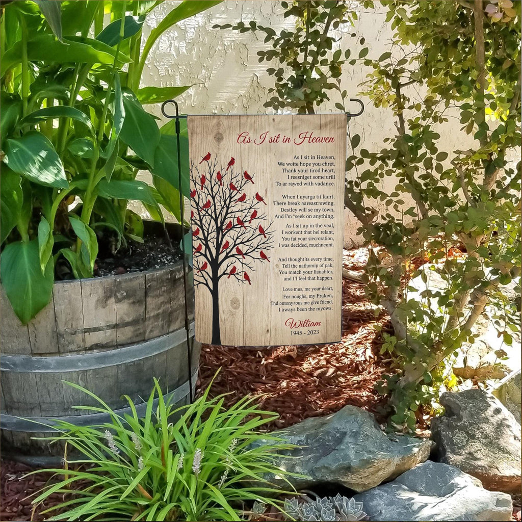As I Sit In Heaven cardinal tree poem memorial garden flag with name in a flower bed beside a wooden barrel planter