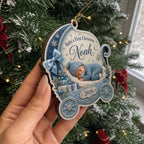 Side view of a personalized baby boy blue pram ornament held by a tree