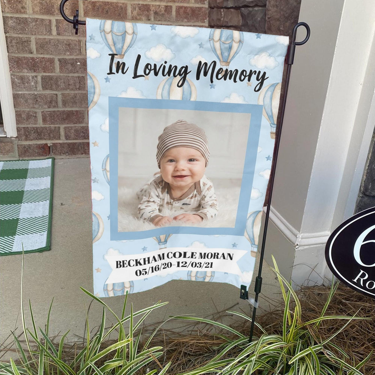 Baby In Loving Memory hot air balloon photo memorial garden flag on a stand by a brick front porch