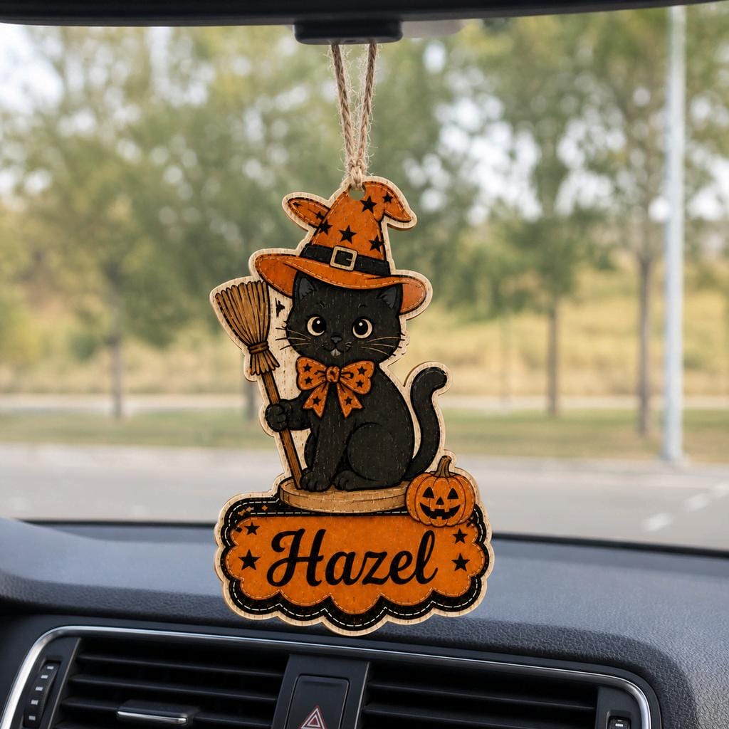 Black cat witch hat name ornament hanging from a car rearview mirror