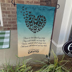 Butterfly heart Those We Love Don't Go Away memorial garden flag on a stand by a brick front porch