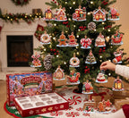 Hand hanging a snowman cupcake ornament on a tree, with the Candyland advent box and its empty insert tray below