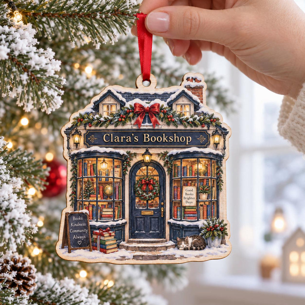 Personalized bookstore wooden ornament hanging on a snowy Christmas tree