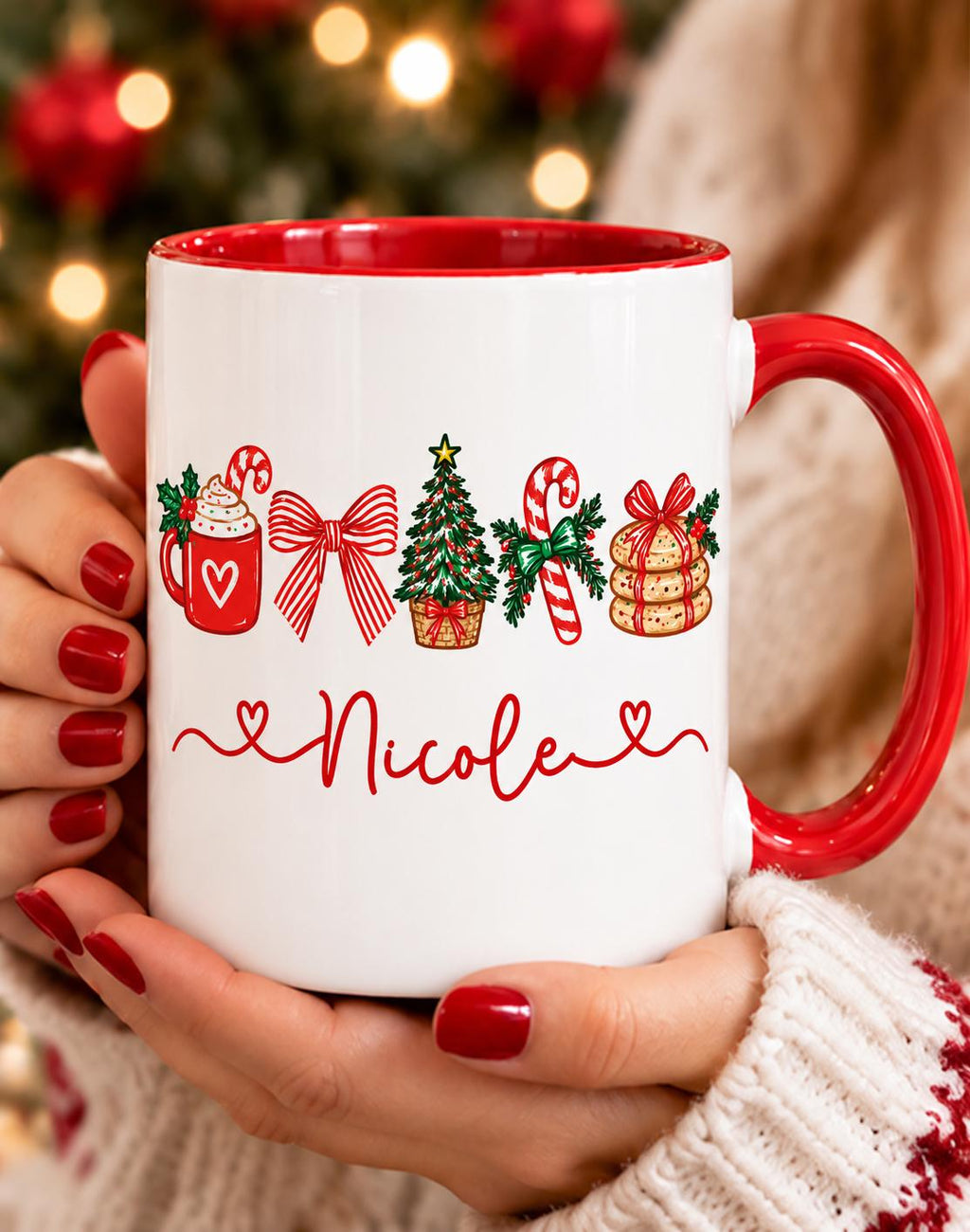 Hands holding a red handle name mug with hot cocoa, candy cane and cookie Christmas design