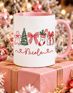 Pink handle Christmas name mug with gingerbread, tree, bow, stocking and gift design