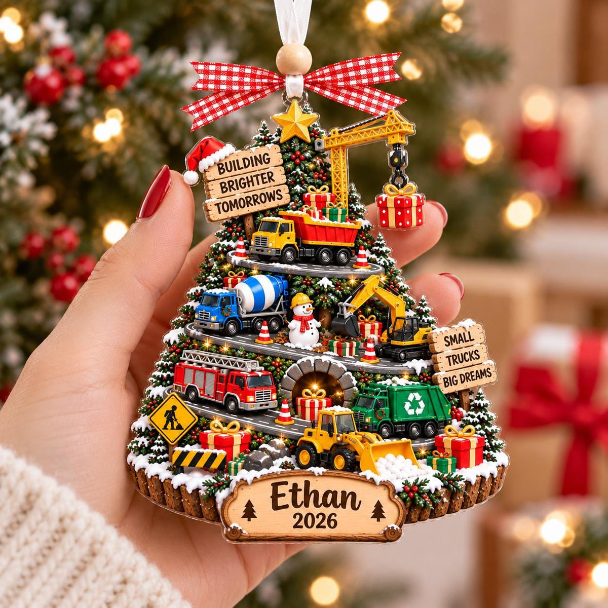 Construction truck tree ornament with Ethan held in a hand