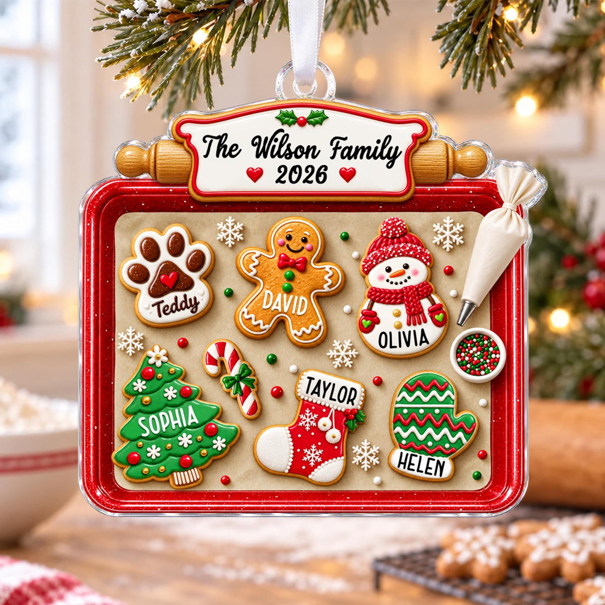 Cookie tray family ornament hanging by a snowy window