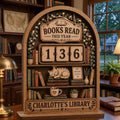 Arched wooden book tracker with a sleeping cat and fairy-light vines, reading Charlotte's Library, on a study desk