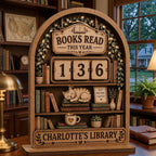 Arched wooden book tracker with a sleeping cat and fairy-light vines, reading Charlotte's Library, on a study desk
