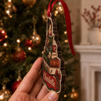 Side view of reading girl ornament with red ribbon showing layered wood thickness