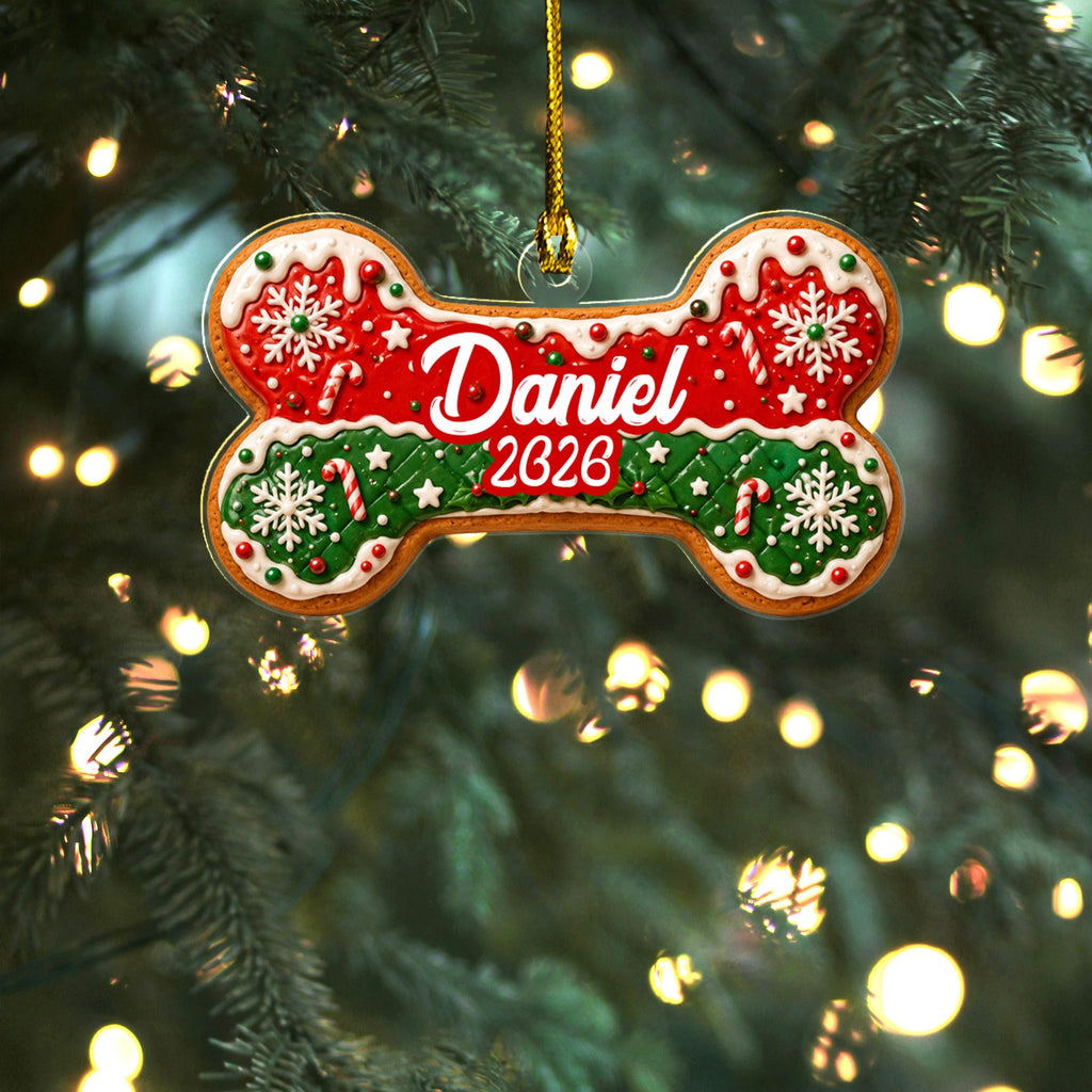 Red and green dog bone name ornament on a lit tree