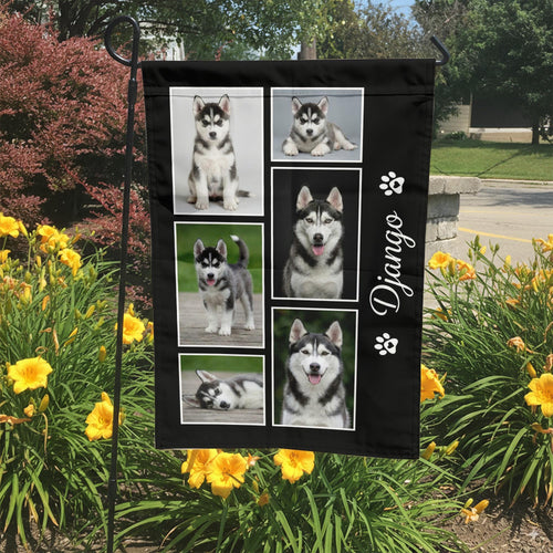 Custom dog photo collage garden flag with name on black in a garden bed with yellow lilies