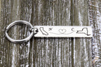 Engraved stainless steel keychain with two state outlines, a dotted heart path and initials