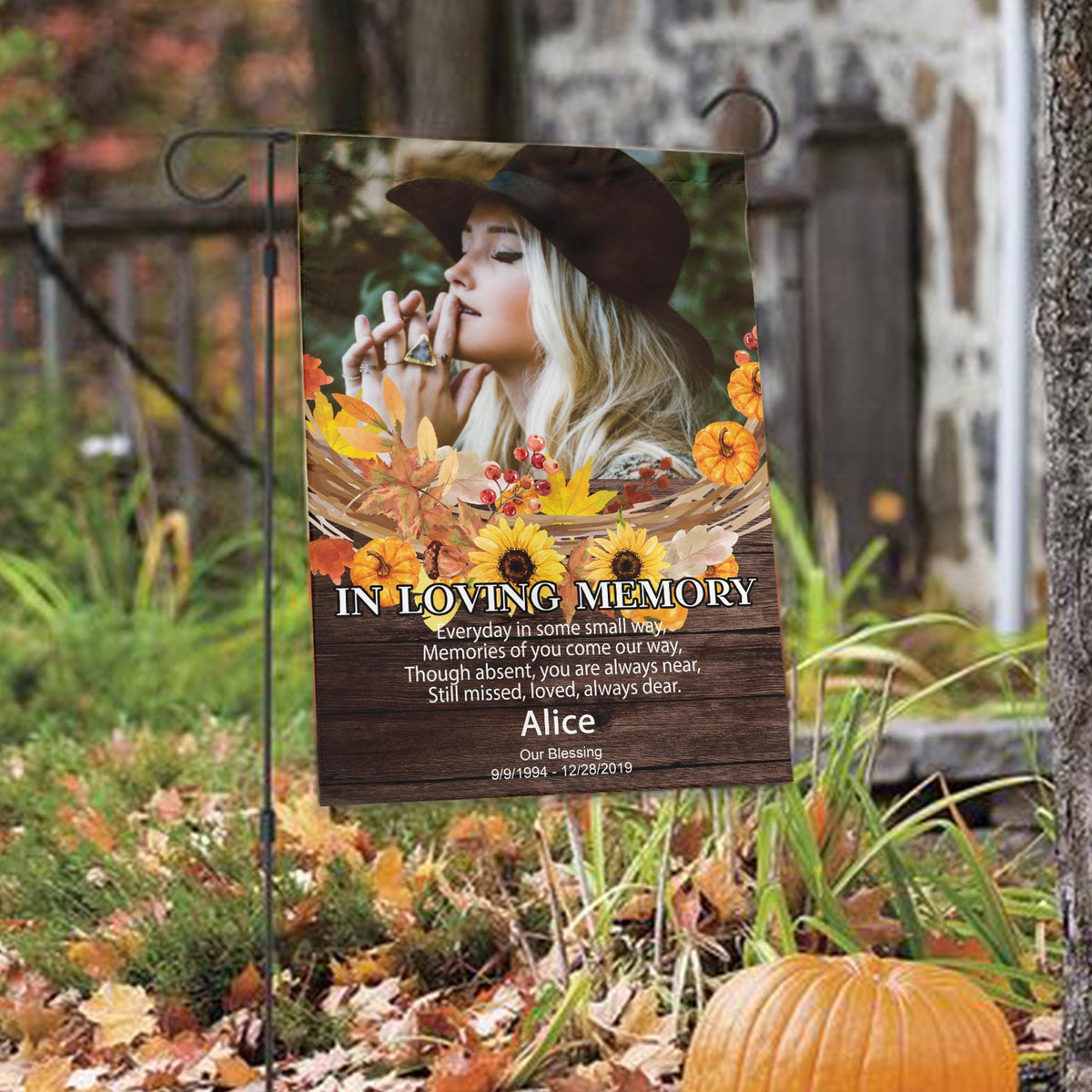 Fall memorial photo garden flag with sunflowers, poem and name among autumn leaves with a pumpkin