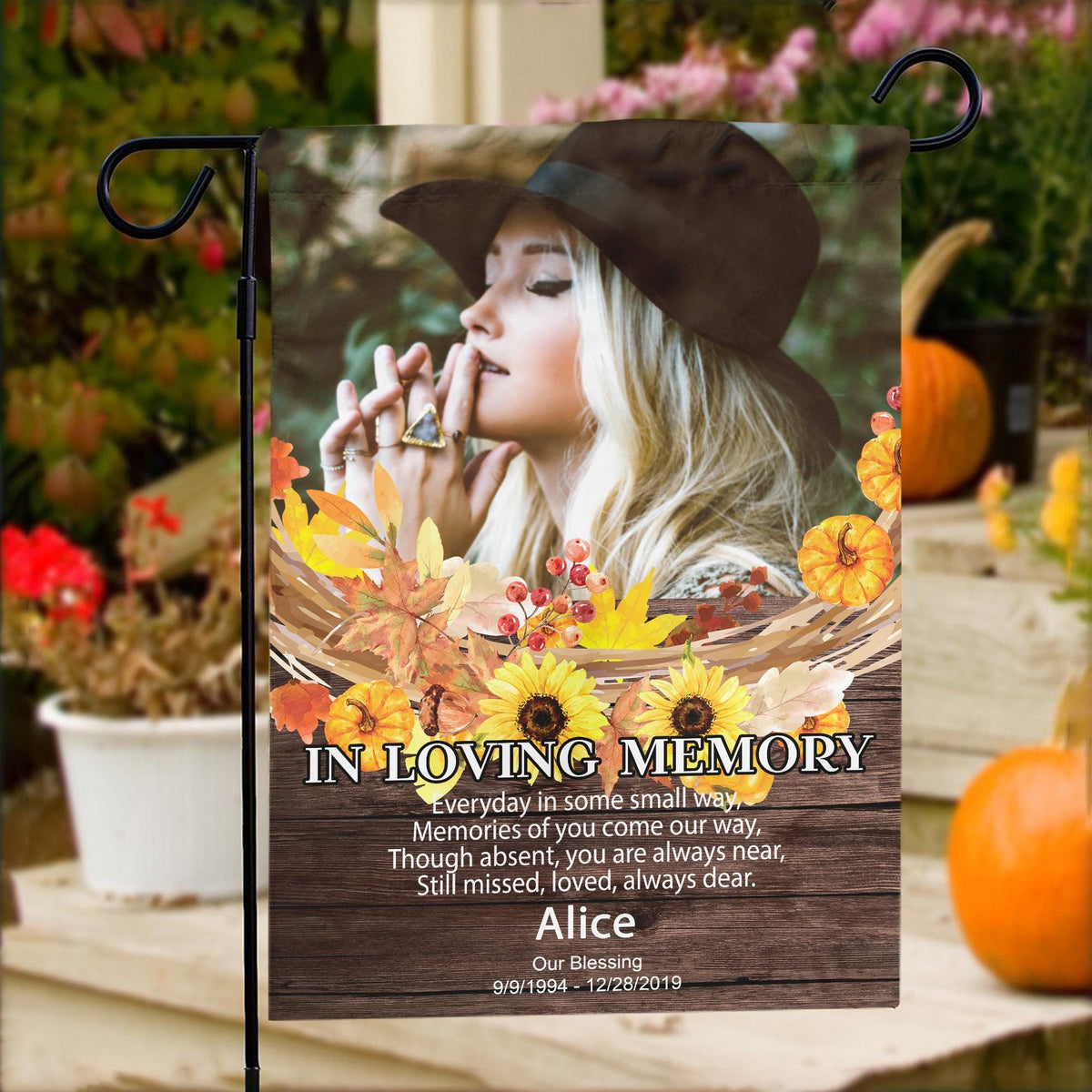 Fall memorial photo garden flag with sunflowers, poem and name on porch steps with pumpkins and flowers