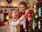Mom and daughter decorating a Christmas tree with personalized snowman name ornaments
