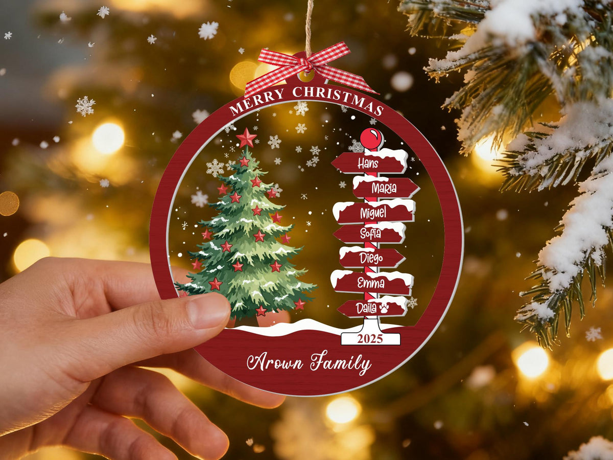 Hand holding the red family names signpost ornament