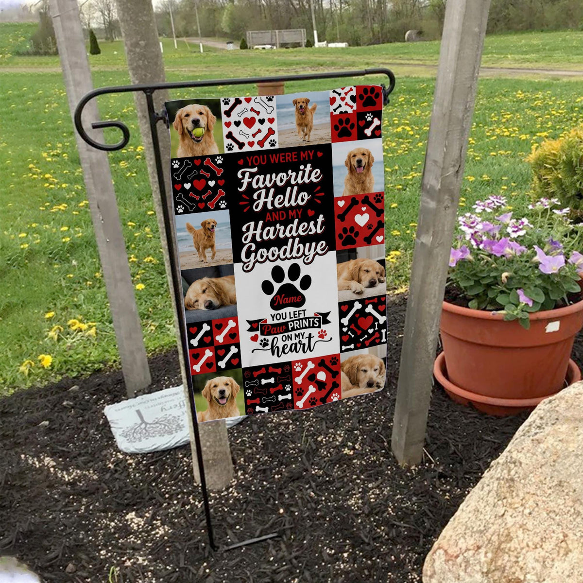Favorite Hello Hardest Goodbye dog memorial photo collage garden flag on a garden flag stand in a yard with potted flowers