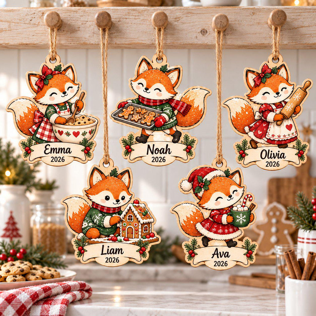 Five personalized fox Christmas wooden ornaments with names and year hanging in a kitchen