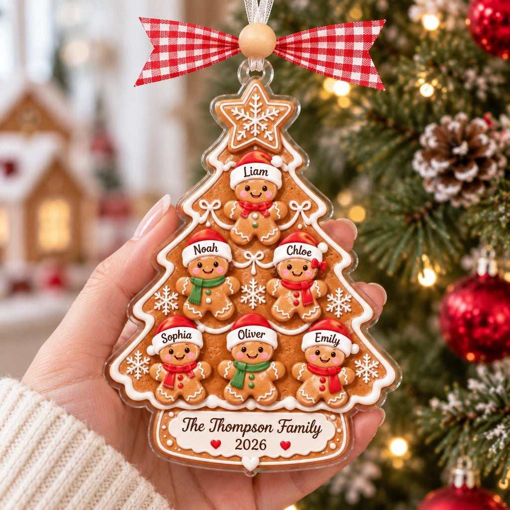 Hand holding a gingerbread family tree ornament with names