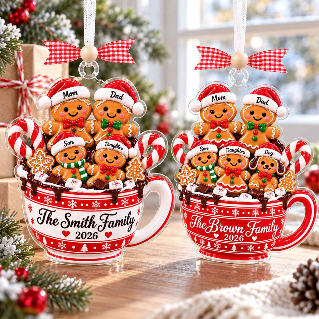 Two gingerbread family mug ornaments with pets on a table