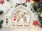 Gingerbread snow globe family ornament on a white faux fur rug