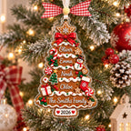 Close-up of gingerbread tree ornament with candy canes, snowman and red bow