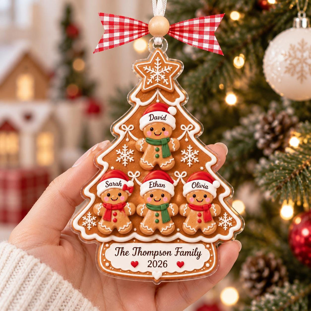 Hand holding a gingerbread tree ornament for a family of four