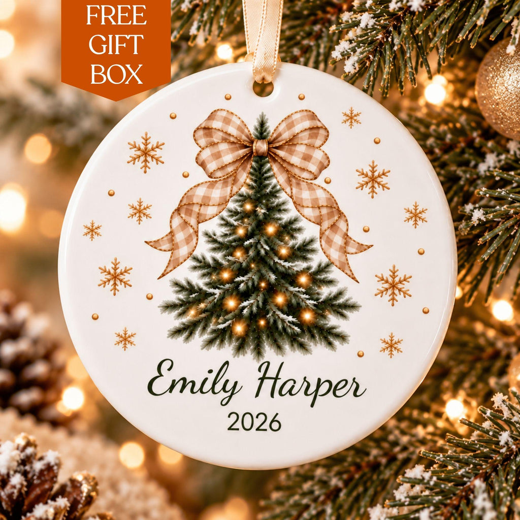 Personalized ceramic Christmas ornament with a beige gingham bow on a tree and Emily Harper 2026