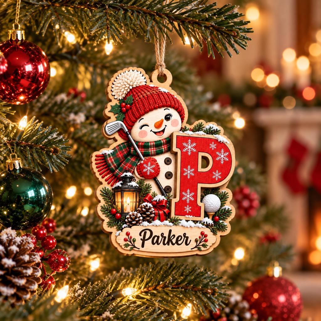 Personalized golf snowman initial ornament with name hanging on a Christmas tree