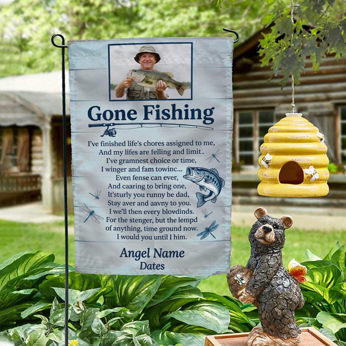 Gone Fishing poem photo memorial garden flag on a garden stand by a log cabin with a beehive and bear statue