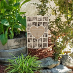 Grandma In Loving Memory heart photo collage garden flag in a flower bed beside a wooden barrel planter