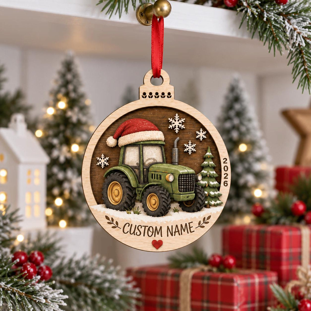 Green tractor in a Santa hat round wooden ornament hanging from a mantel above gifts