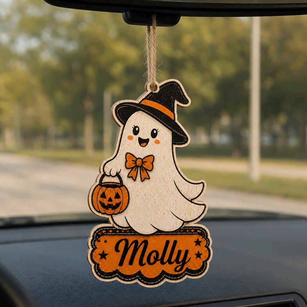 Cute ghost witch hat name ornament hanging from a car rearview mirror