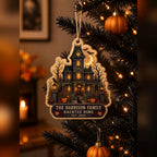 Family name haunted home wooden ornament hanging on a black Halloween tree with lights