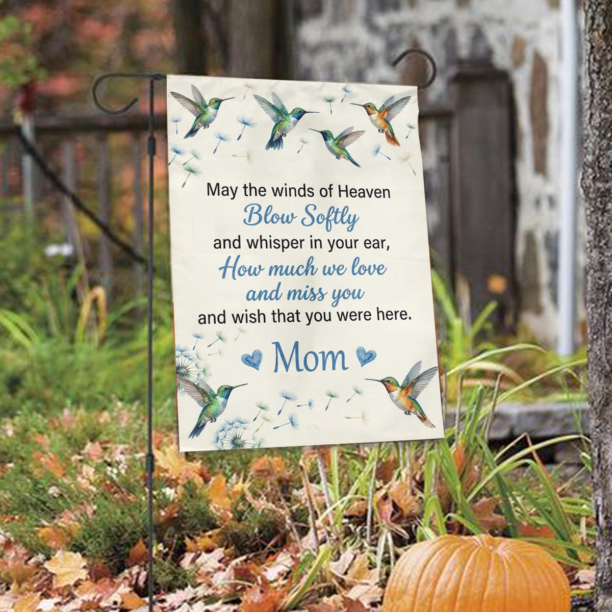 Hummingbird May the Winds of Heaven memorial garden flag among autumn leaves with a pumpkin