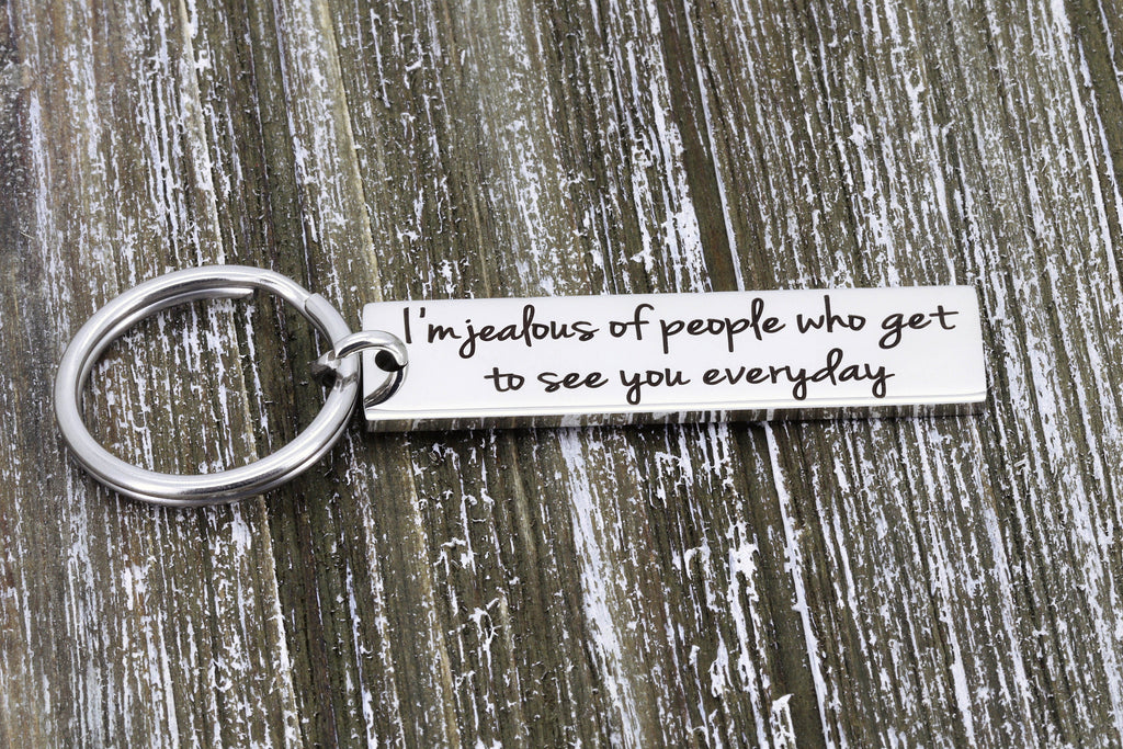 Back of the keychain engraved with I'm jealous of people who get to see you everyday