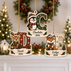 Reindeer D, penguin C and fox E kids initial name ornaments on a mantel