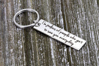 Keychain with an engraved long distance love message on rustic wood