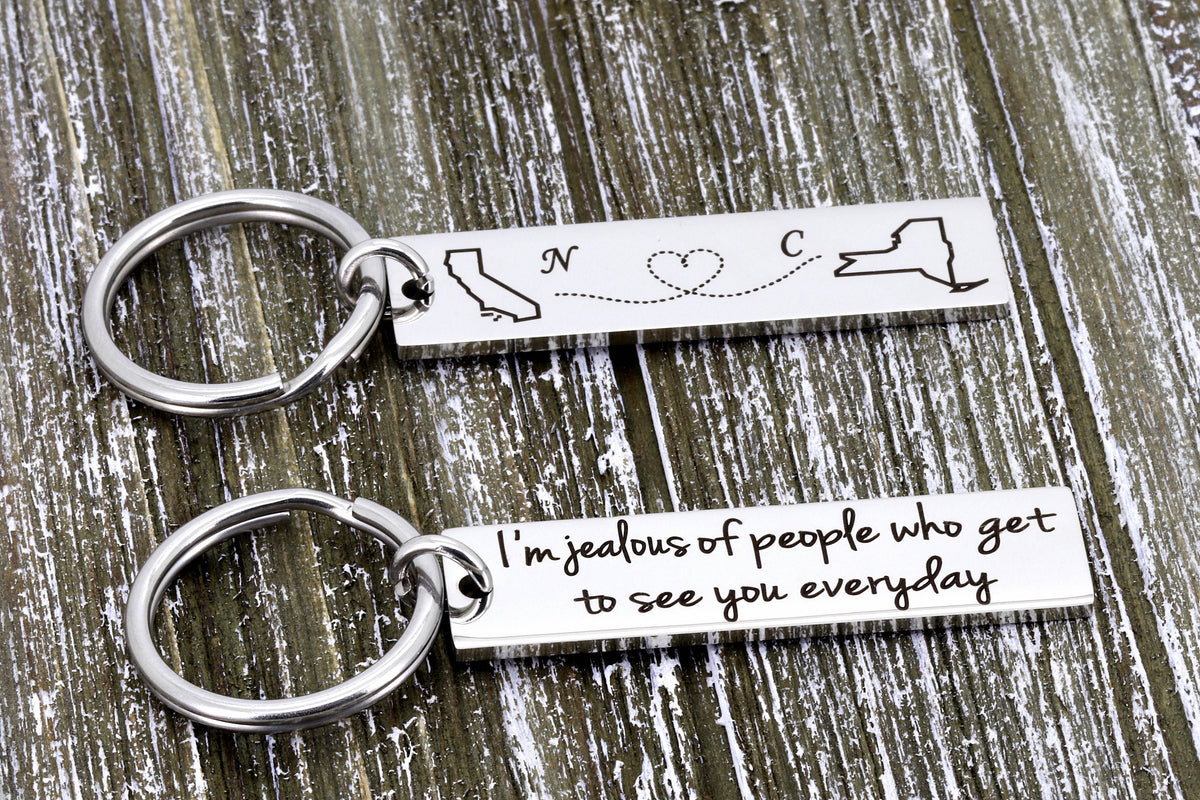 Long distance keychain with California and New York outlines, initials N and C, and a back message