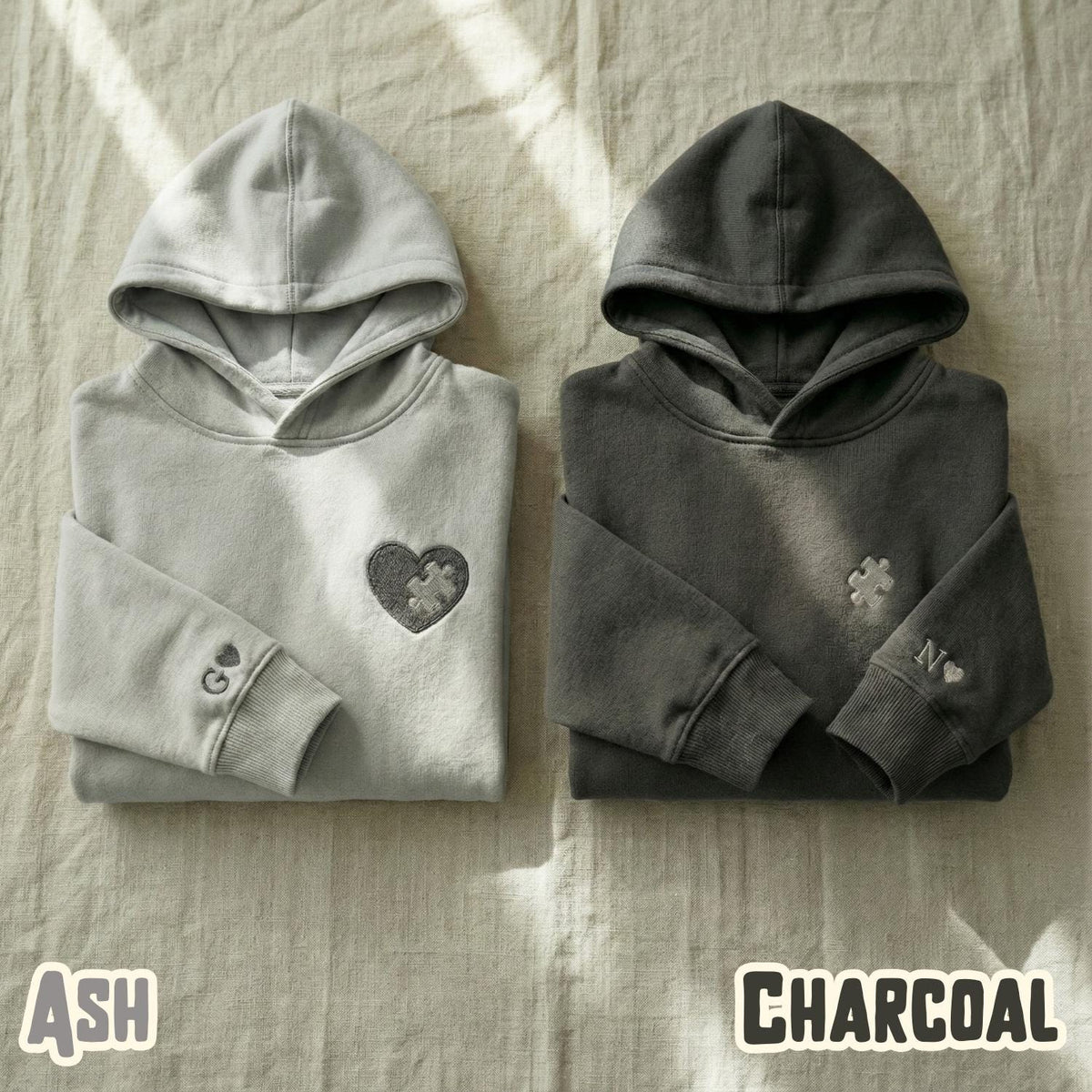 Ash and charcoal matching couple hoodies with an embroidered puzzle heart and puzzle piece