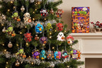 Frankenstein, mummy, devil and blue monster acrylic pieces hanging on a tree with the box on the mantel