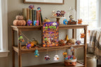 Monster acrylic pieces on a wooden shelf and garland with the box, books, pumpkins and a spooky sign