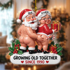 Cheeky Santa couple ornament Design 9 holding a gift