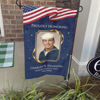 Proudly Honoring military veteran photo memorial garden flag with American flag banner on a stand by a brick front porch
